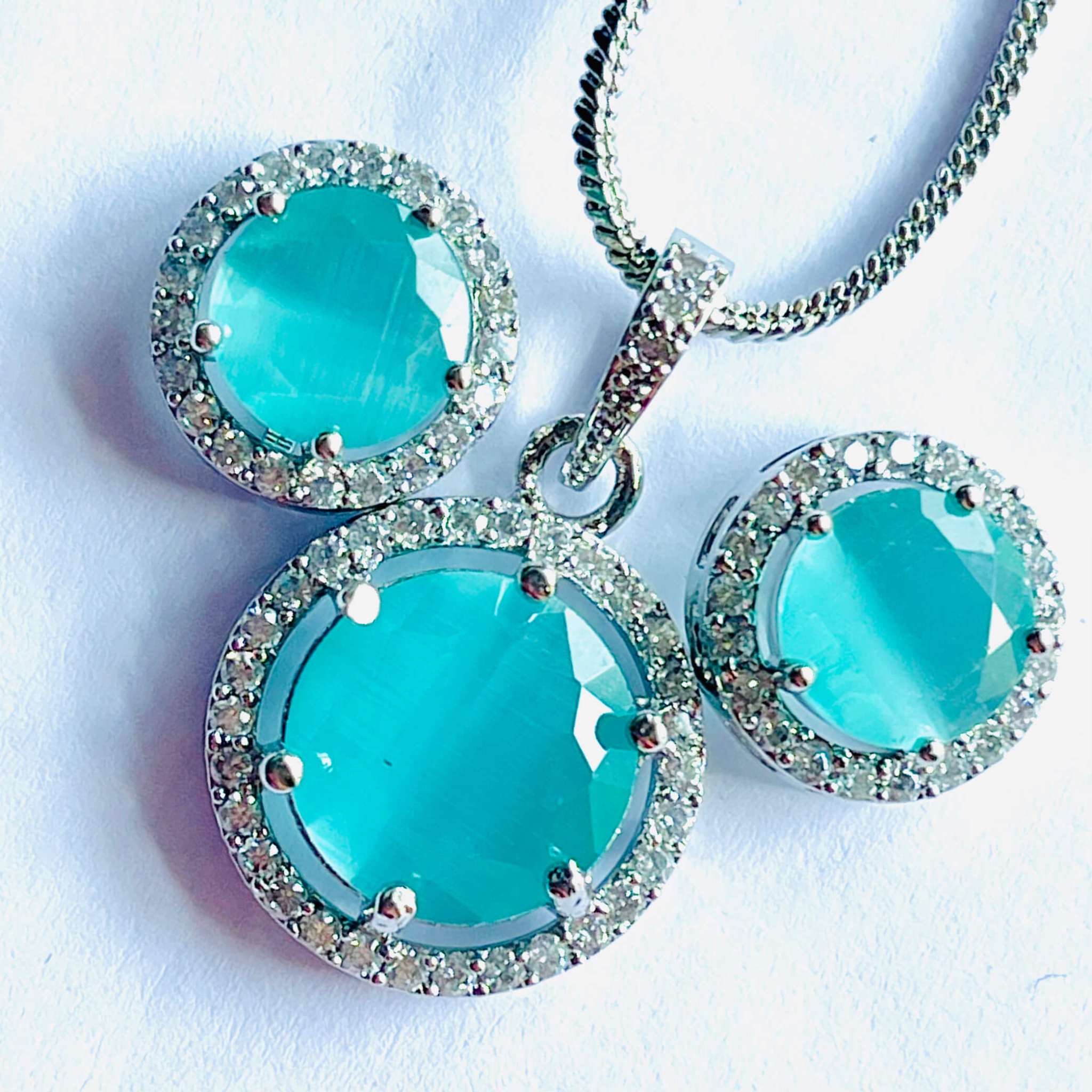 Teal Majestic Moonlit round pendant and matching earrings set with silver and AD stones