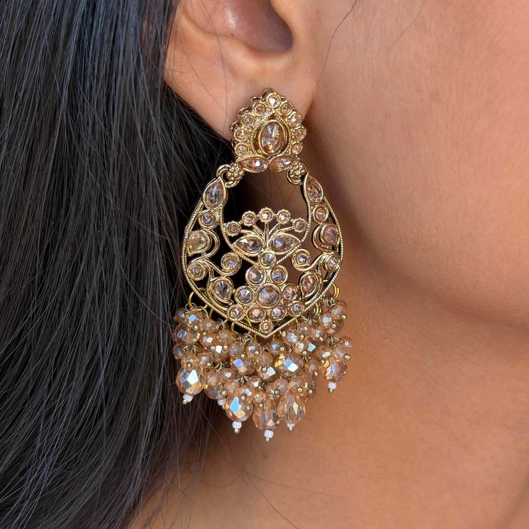 Dhoop Lehar Boondein Jhumke gold-tone intricate earrings with dangling bead clusters, worn on ear