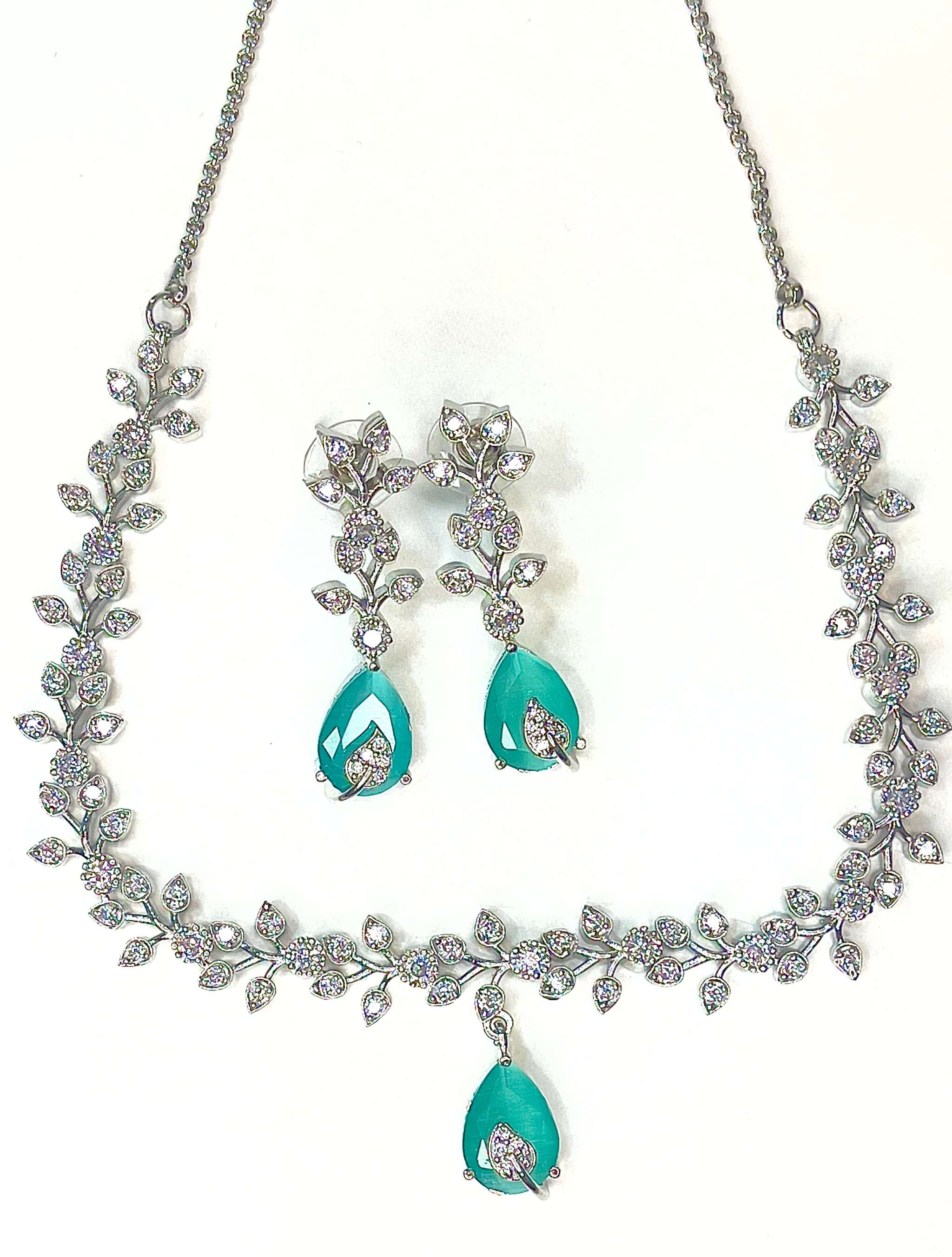 Aqua Boom Amora Necklace Set featuring silver chain with crystal floral design and aqua teardrop pendants with matching earrings