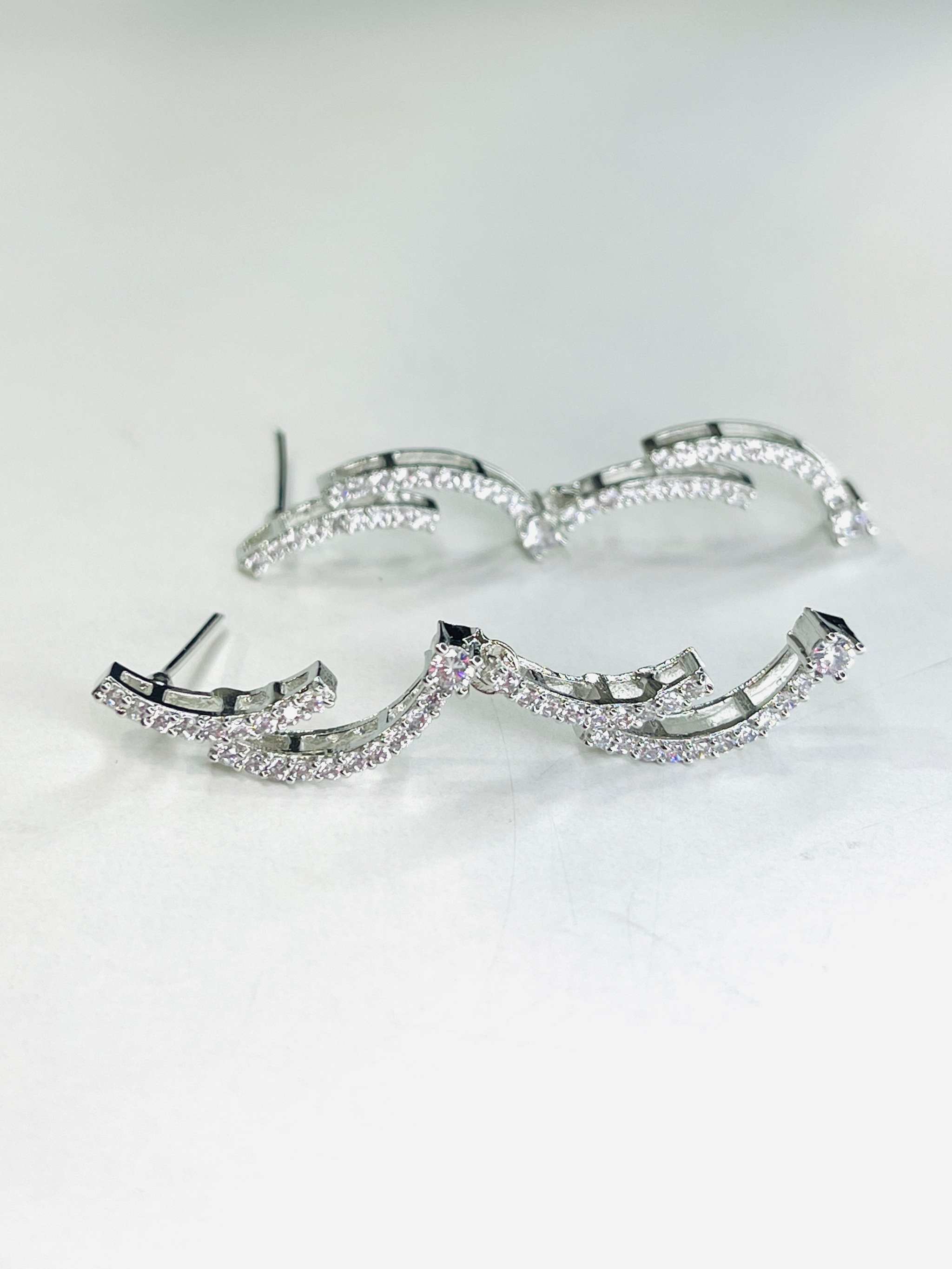 Silver crescent silhouette necklace set with sparkling stones and elegant curved design