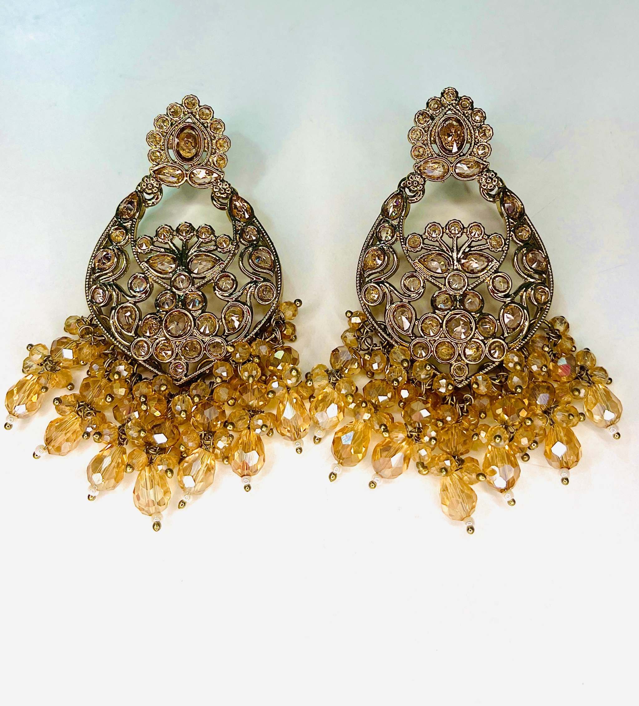 Dhoop Lehar Boondein Jhumke ornate gold-tone earrings with intricate floral design and amber bead drops