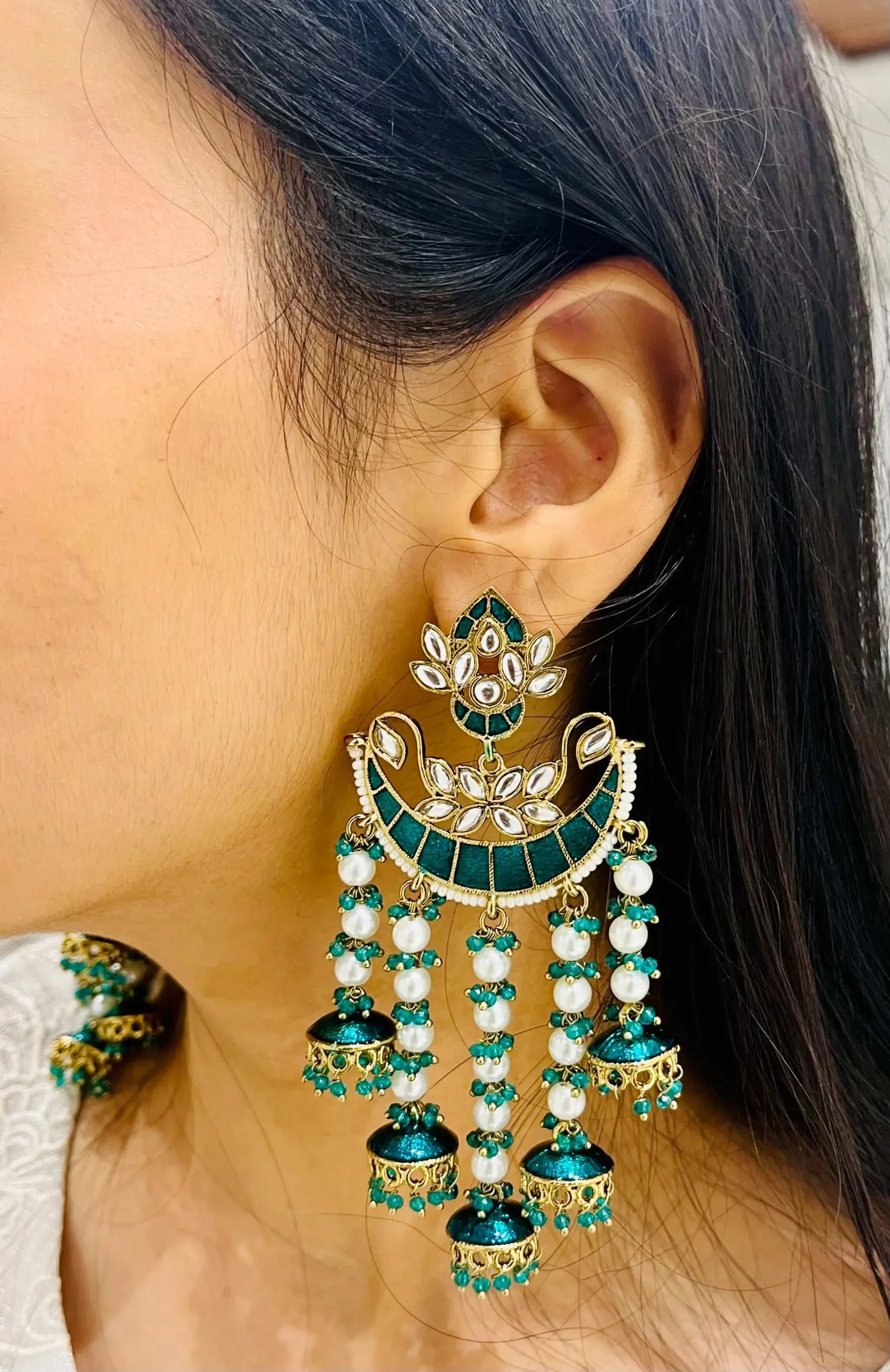 Moti Barish Sabz Jhumki featuring green accents and pearl drops worn on ear