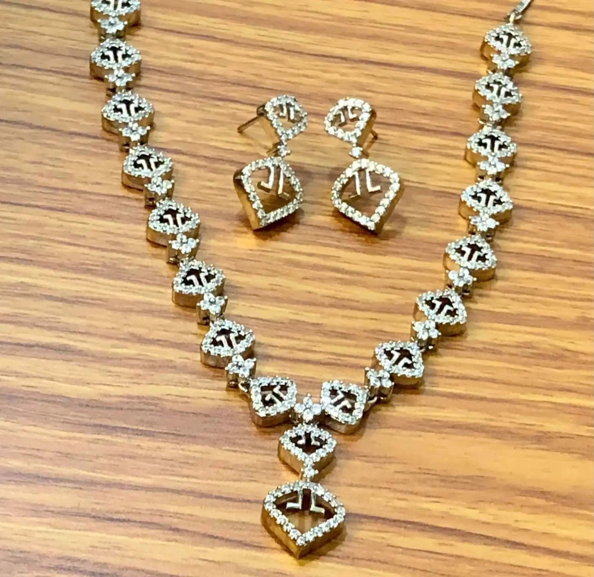Elegant white zircon necklace set with sparkling AD stones on wooden surface