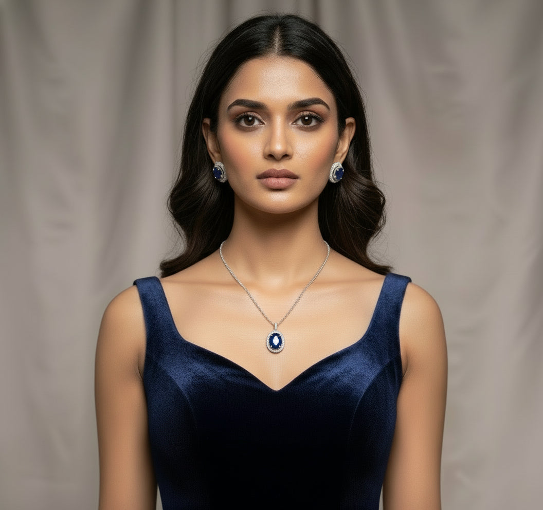 Blue and silver oval pendant and earring set with deep blue stones and surrounding clear AD stones