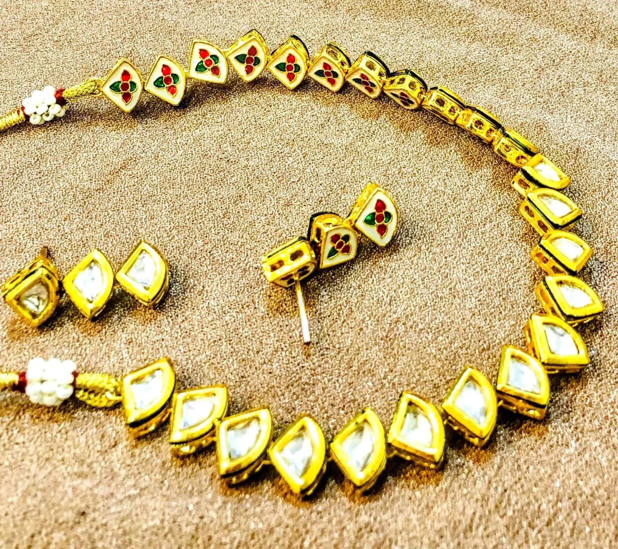 Golden and white triangular Kundan meenakari necklace set with intricate craftsmanship and vibrant colors for weddings and special occasions