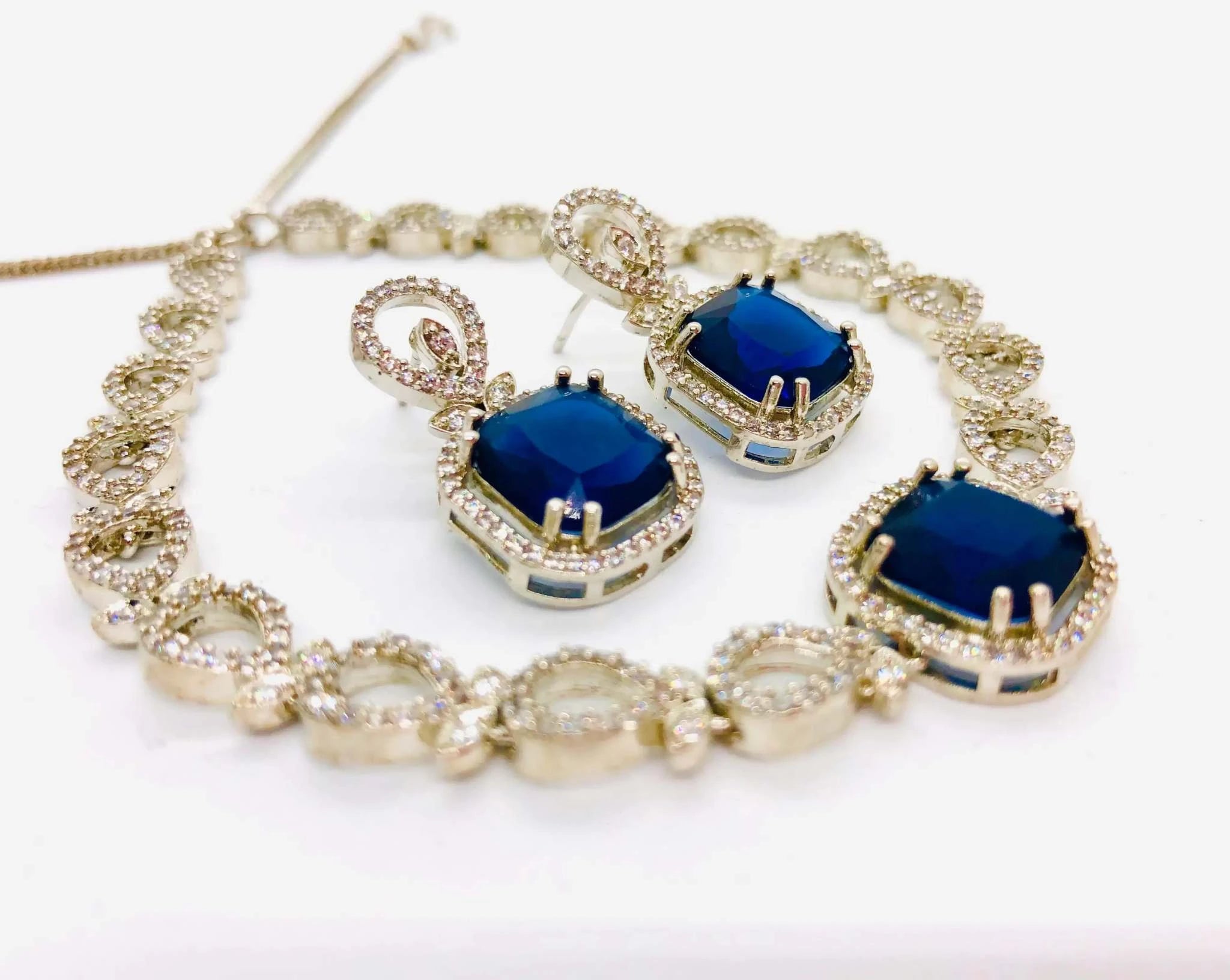 Honeycomb Jewelry Set with sapphire blue crystals necklace and matching earrings on white background