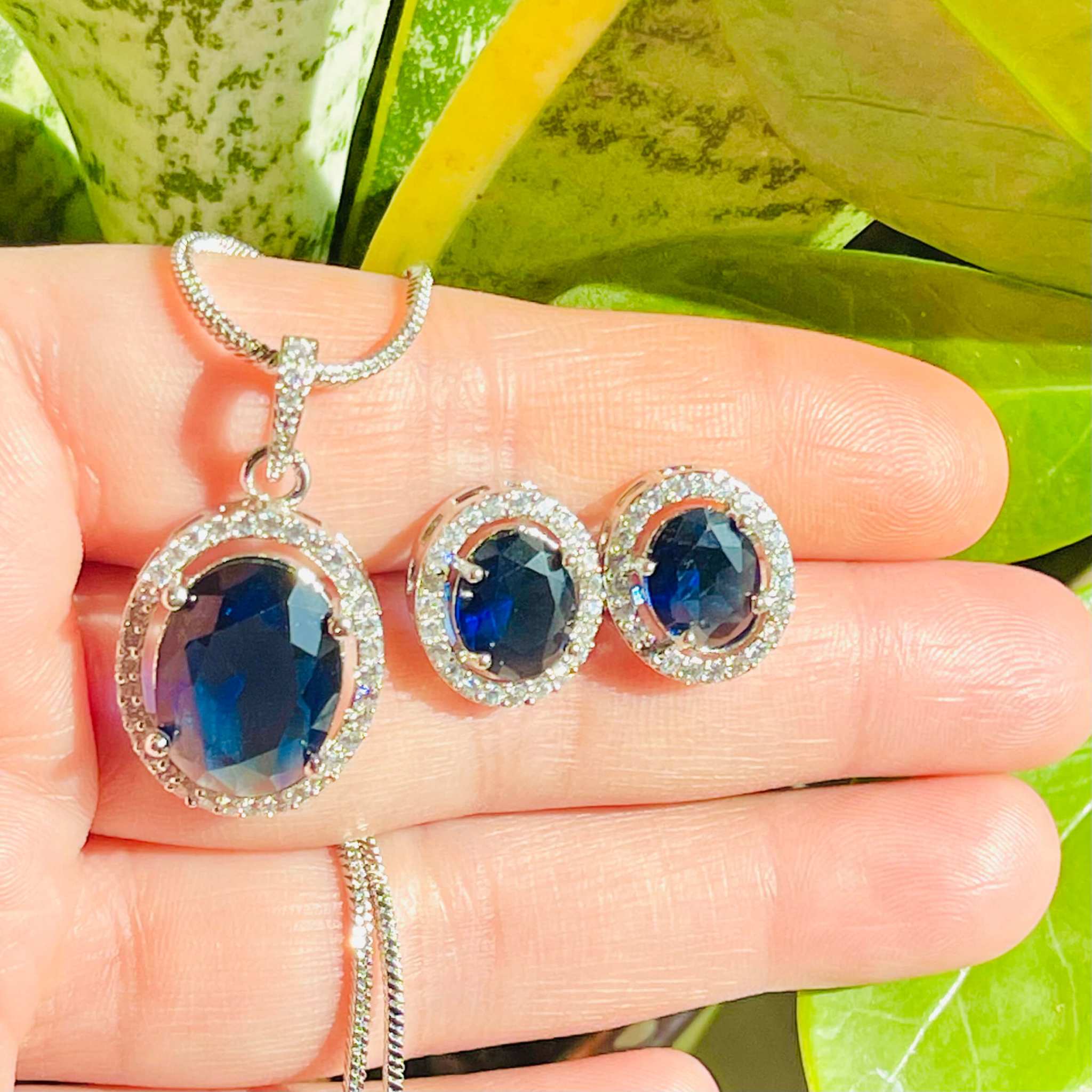 Indigo Grand Pendant Set with oval indigo stone and surrounding white diamonds on silver chain