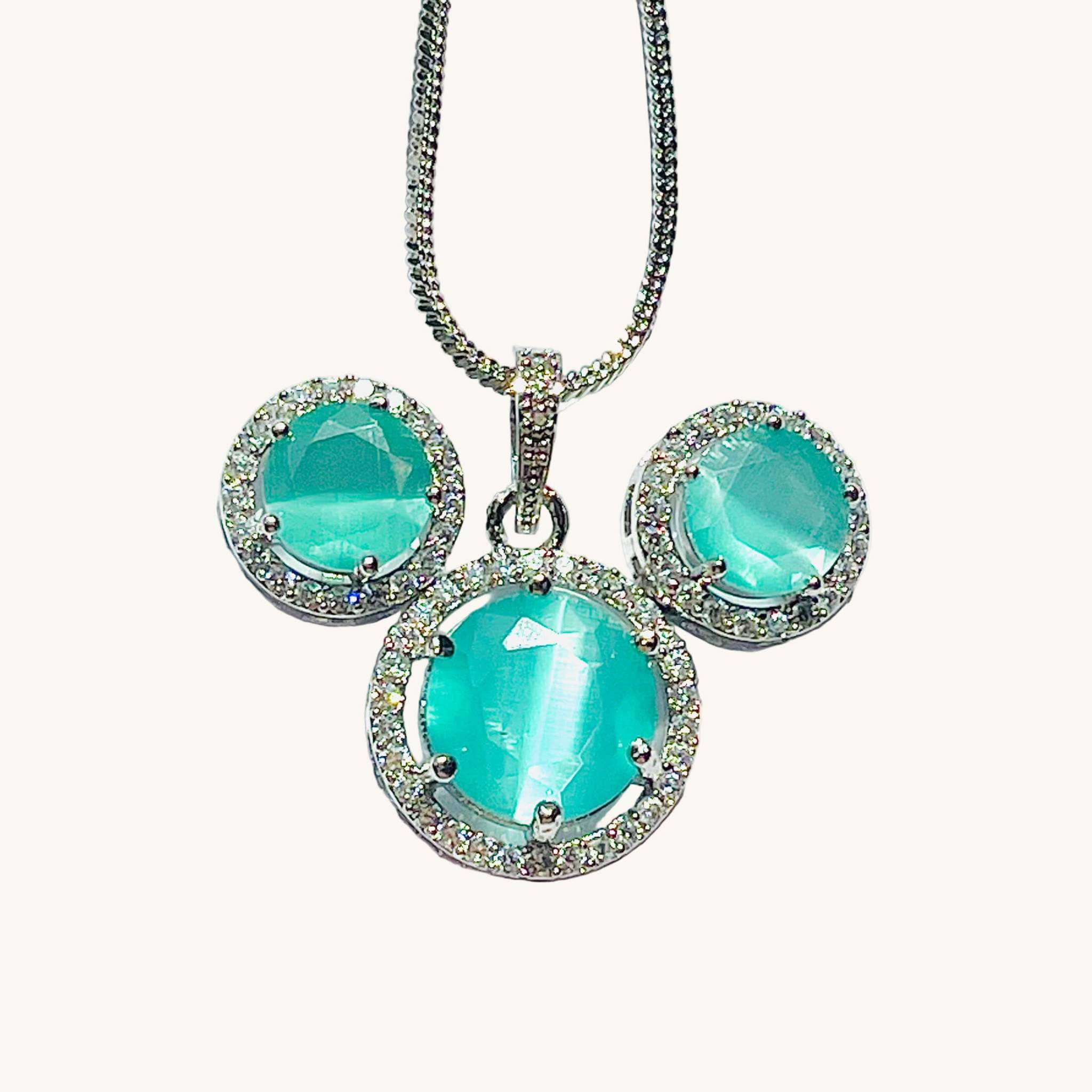 Teal Majestic Moonlit round pendant and matching earrings set with AD stones on silver chain