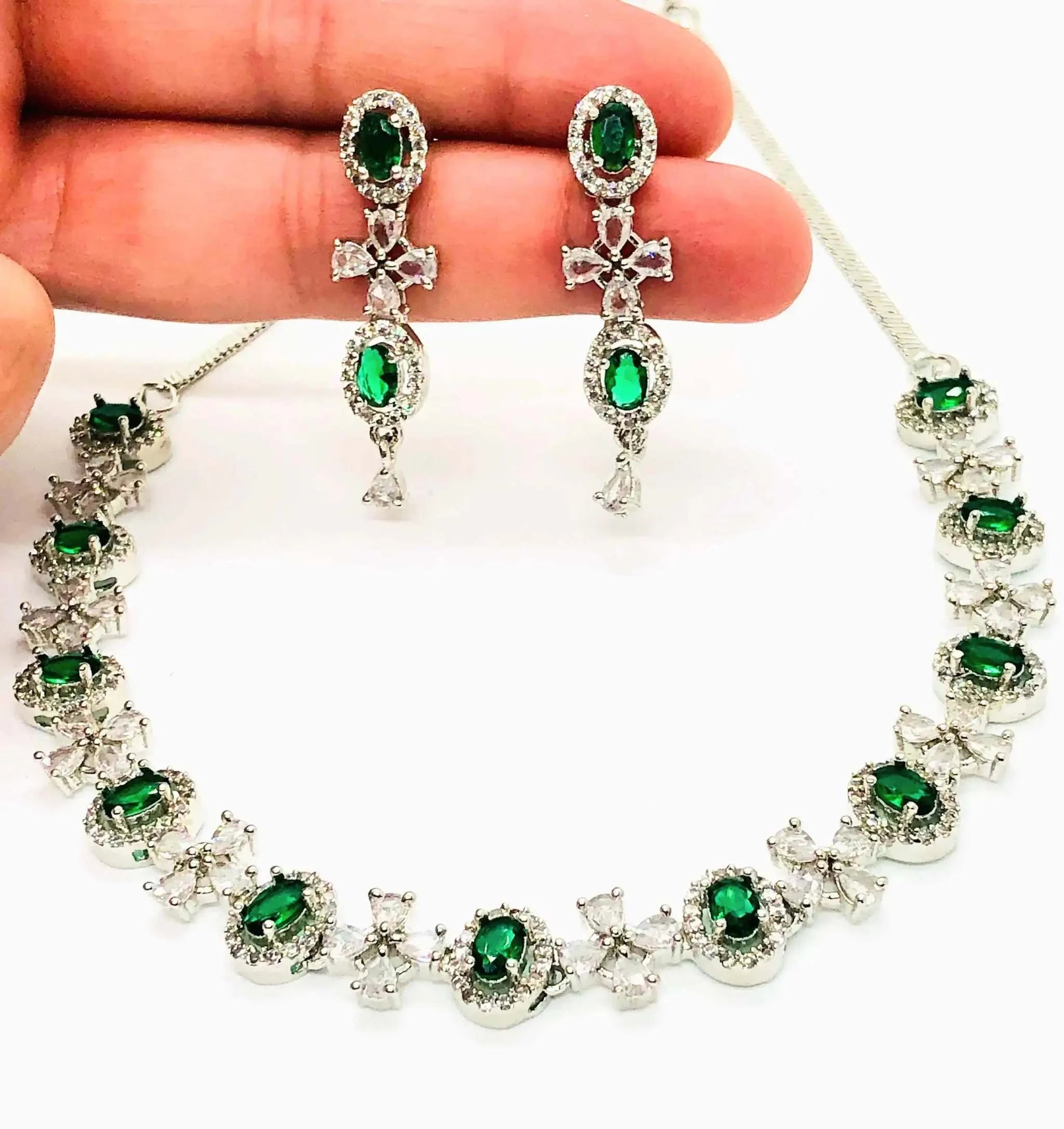 Elegant green gemstone necklace and matching earrings set with silver detailing