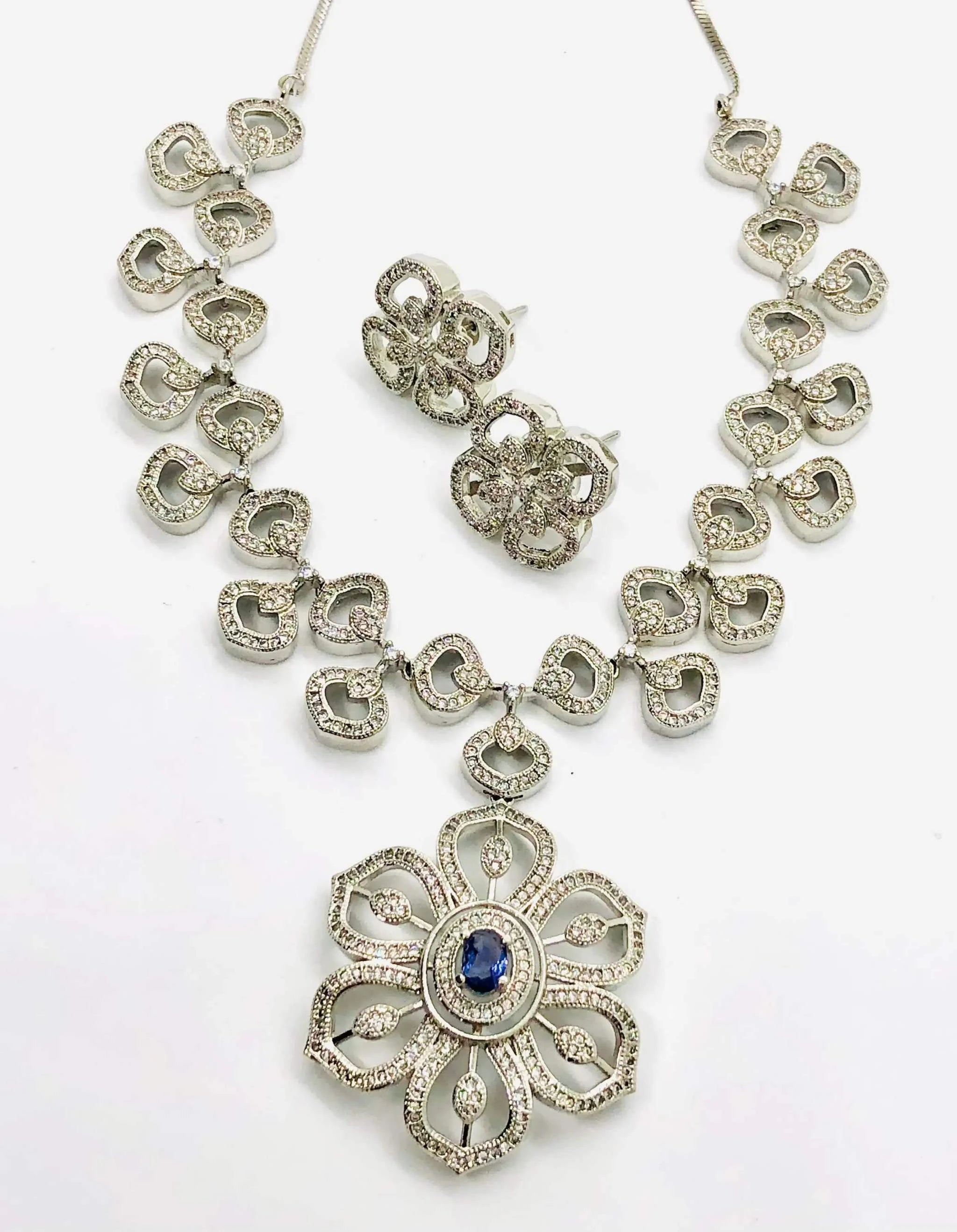 Dazzling white floral crystal necklace set with matching earrings featuring intricate flower design and sparkling clear crystals