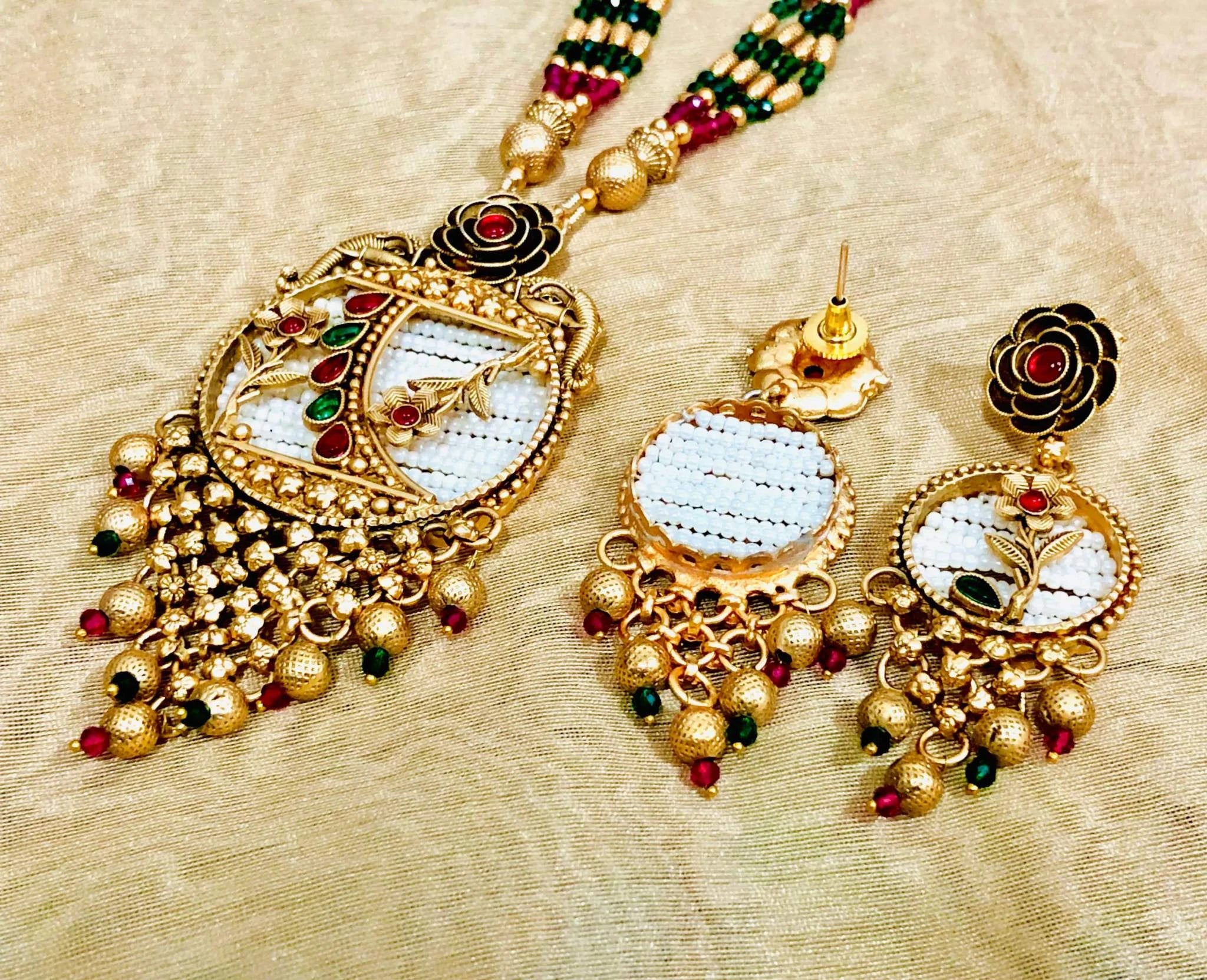 Elegant Patwa Rice Jewelry Set in pink and green with intricate gold detailing and bead accents
