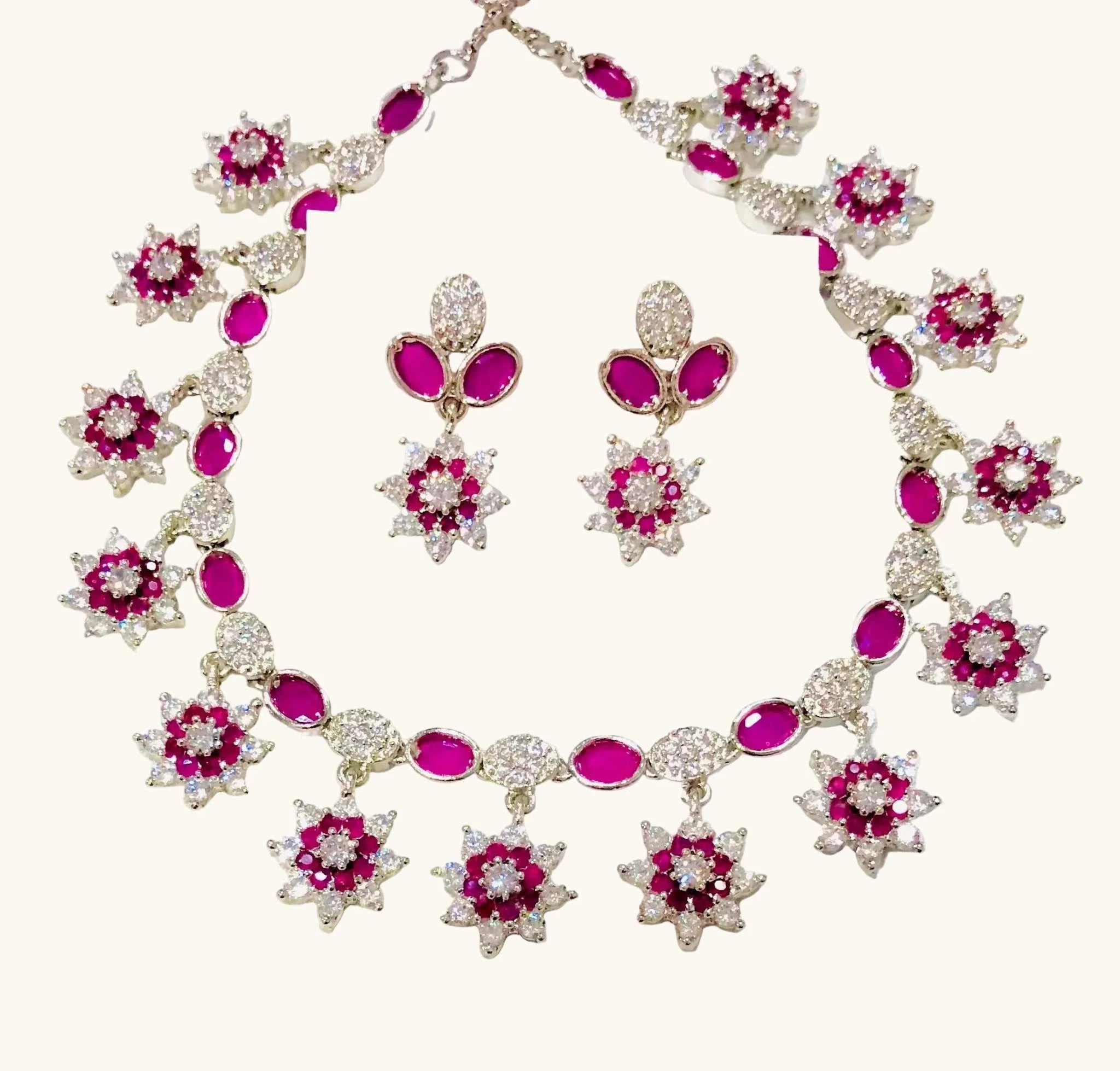 Elegant white and burgundy crystal necklace and earrings set with floral design and sparkling accents