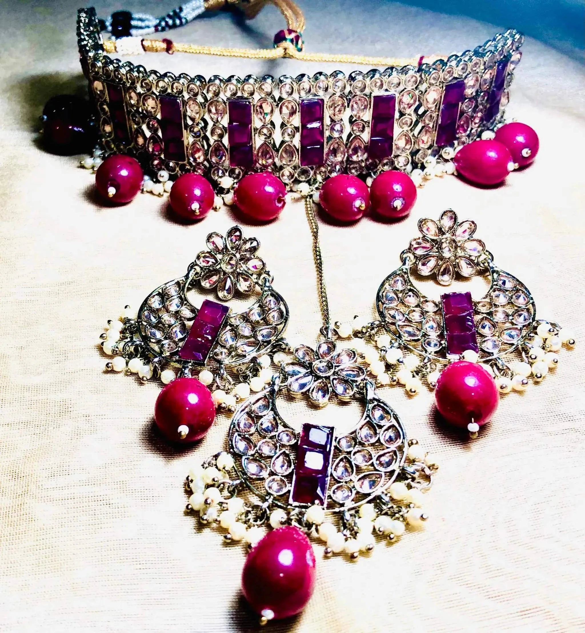Elegant rose red Rajwadi choker set with traditional gemstone detailing and matching earrings for special occasions