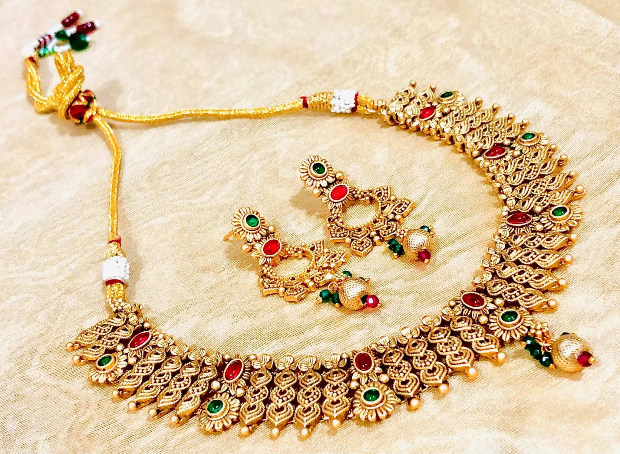 Golden Mehendi Necklace Set with intricate traditional Indian mehendi design and matching designer earrings adorned with red and green stones