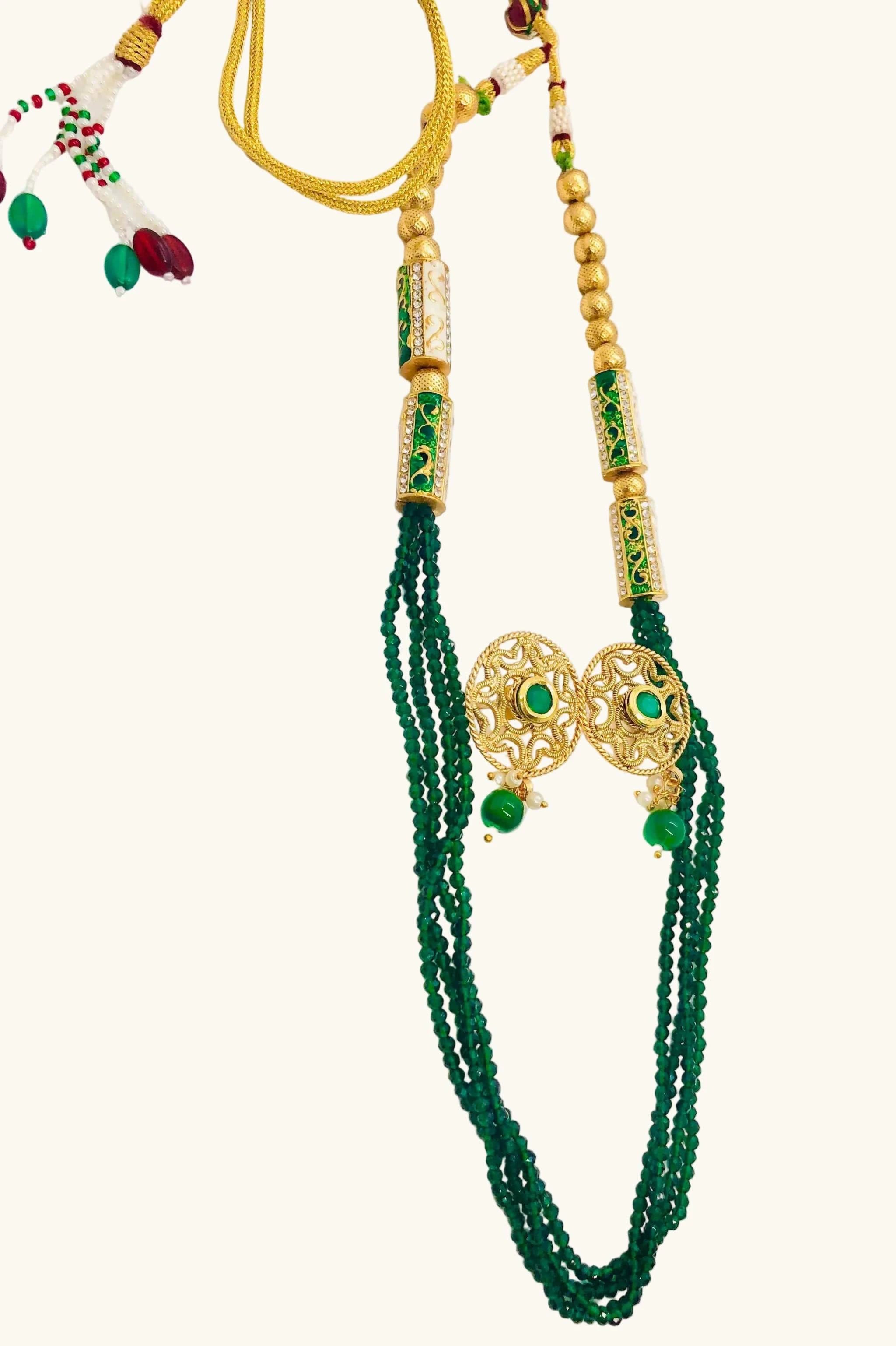 Golden and emerald beaded jewelry set with intricate gold detailing and vibrant green beads, featuring a matching necklace and earrings.
