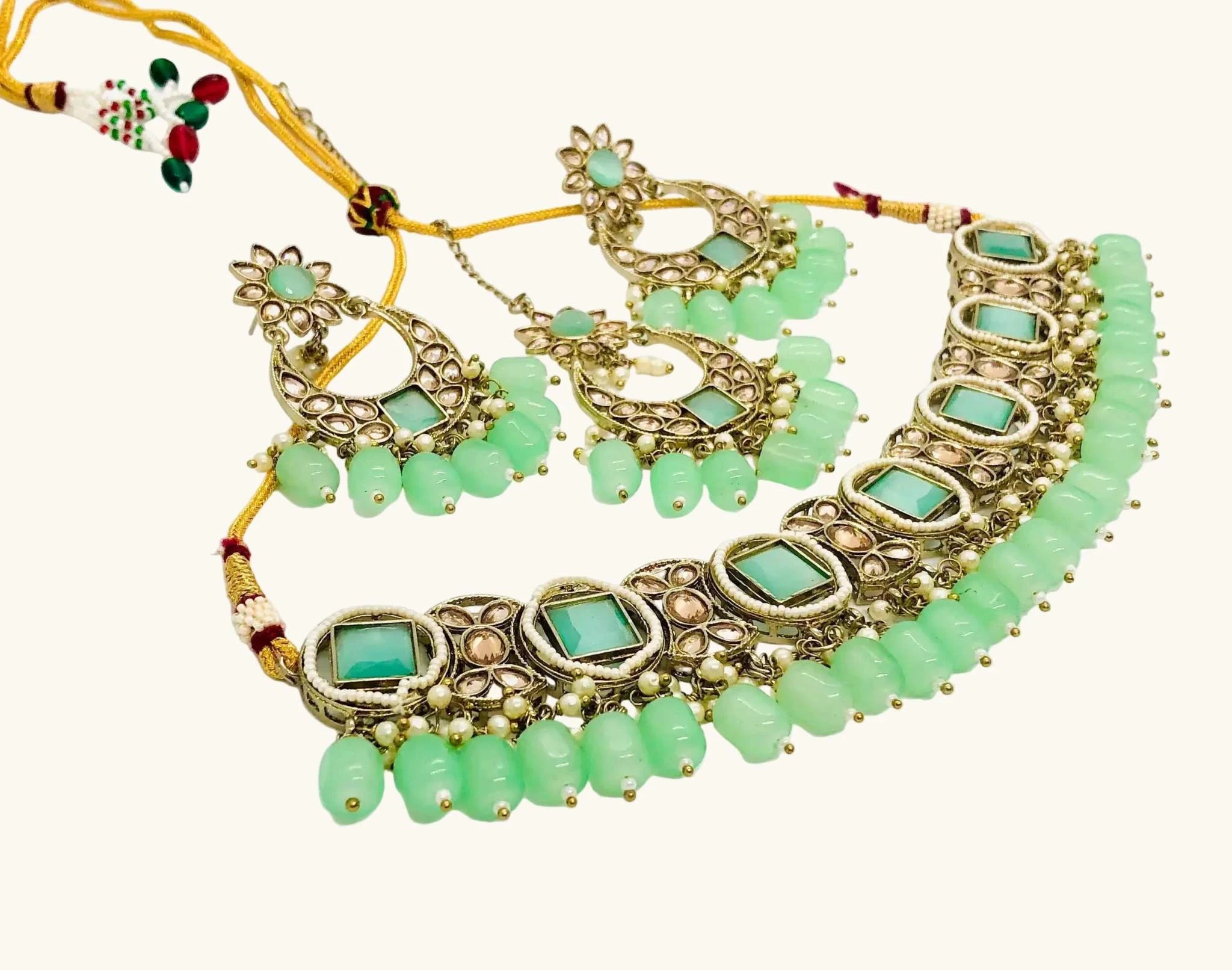 Grape Green Rajwadi Jewelry Set featuring an antique finish choker and matching earrings with green beads and intricate design