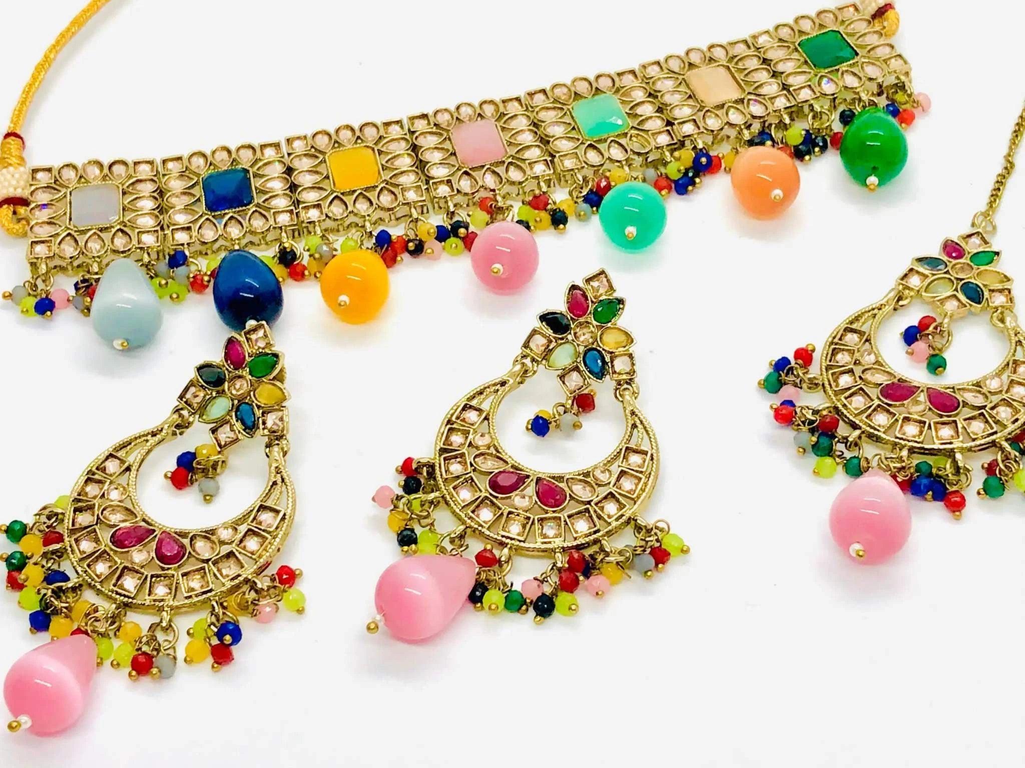 Multicolour Rajwadi necklace set with intricate gold design, multicolored stones, handmade pearls, and matching earrings with maang tikka