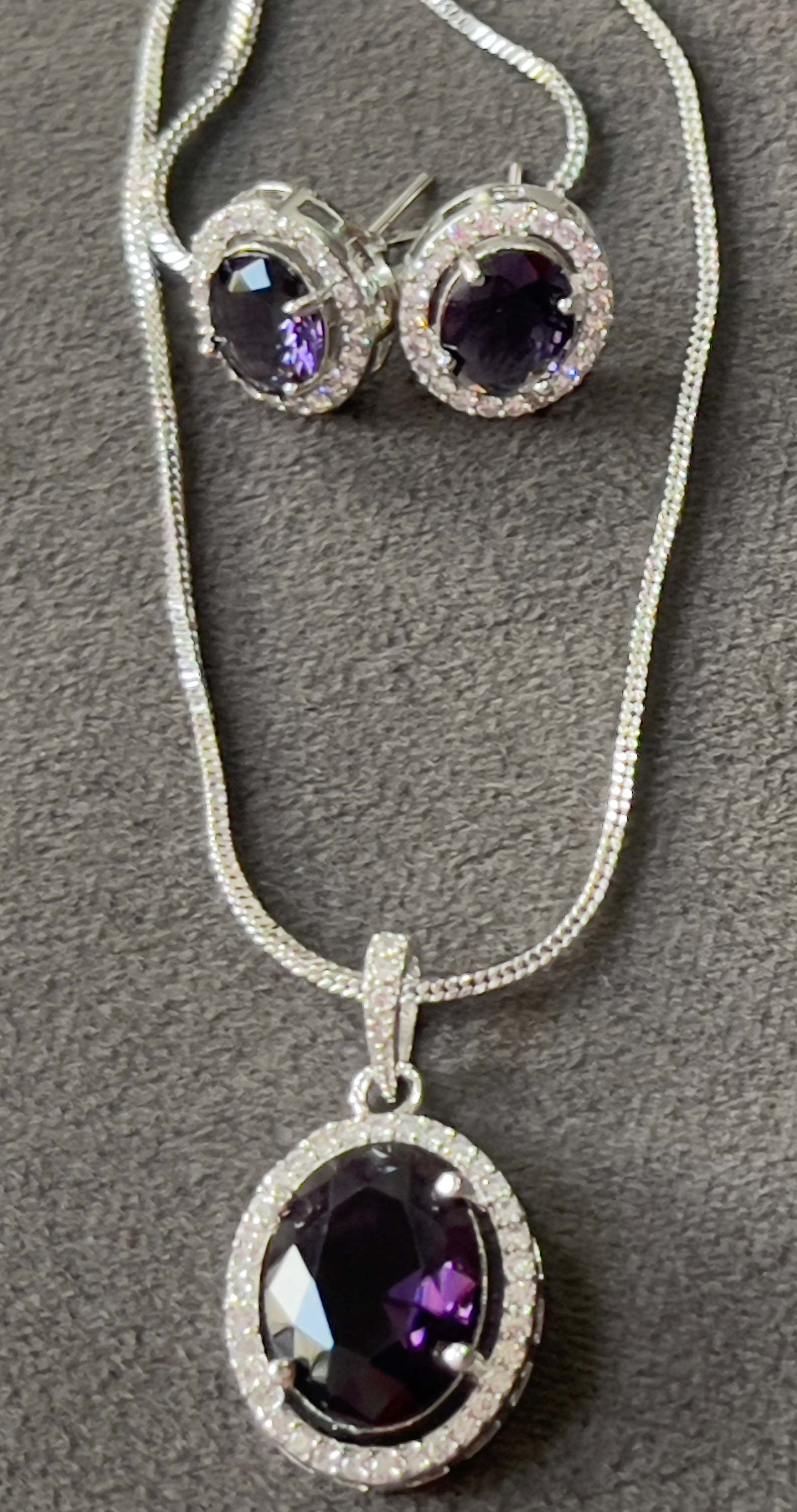 Violet Oval Grand Pendant Set featuring an oval violet gemstone pendant and matching earrings with silver settings