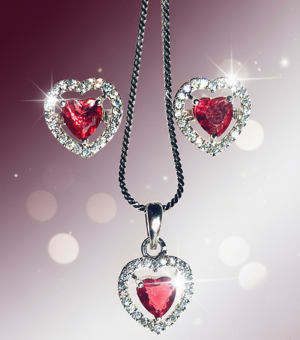 Silver and red heart-shaped pendant and earrings set with AD stones on a chain necklace