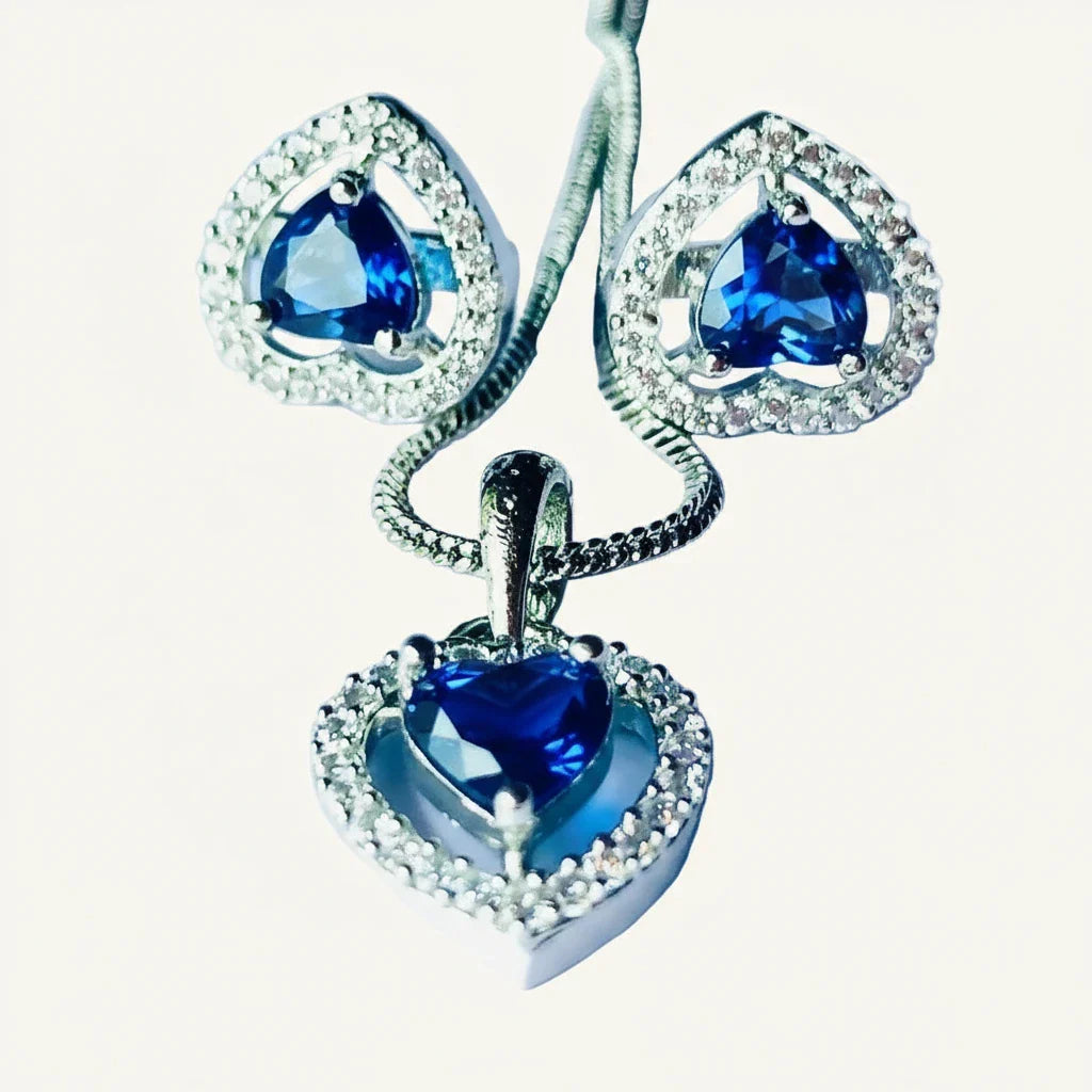 Heart-shaped blue and silver pendant and earrings set with blue zircon and silver accents