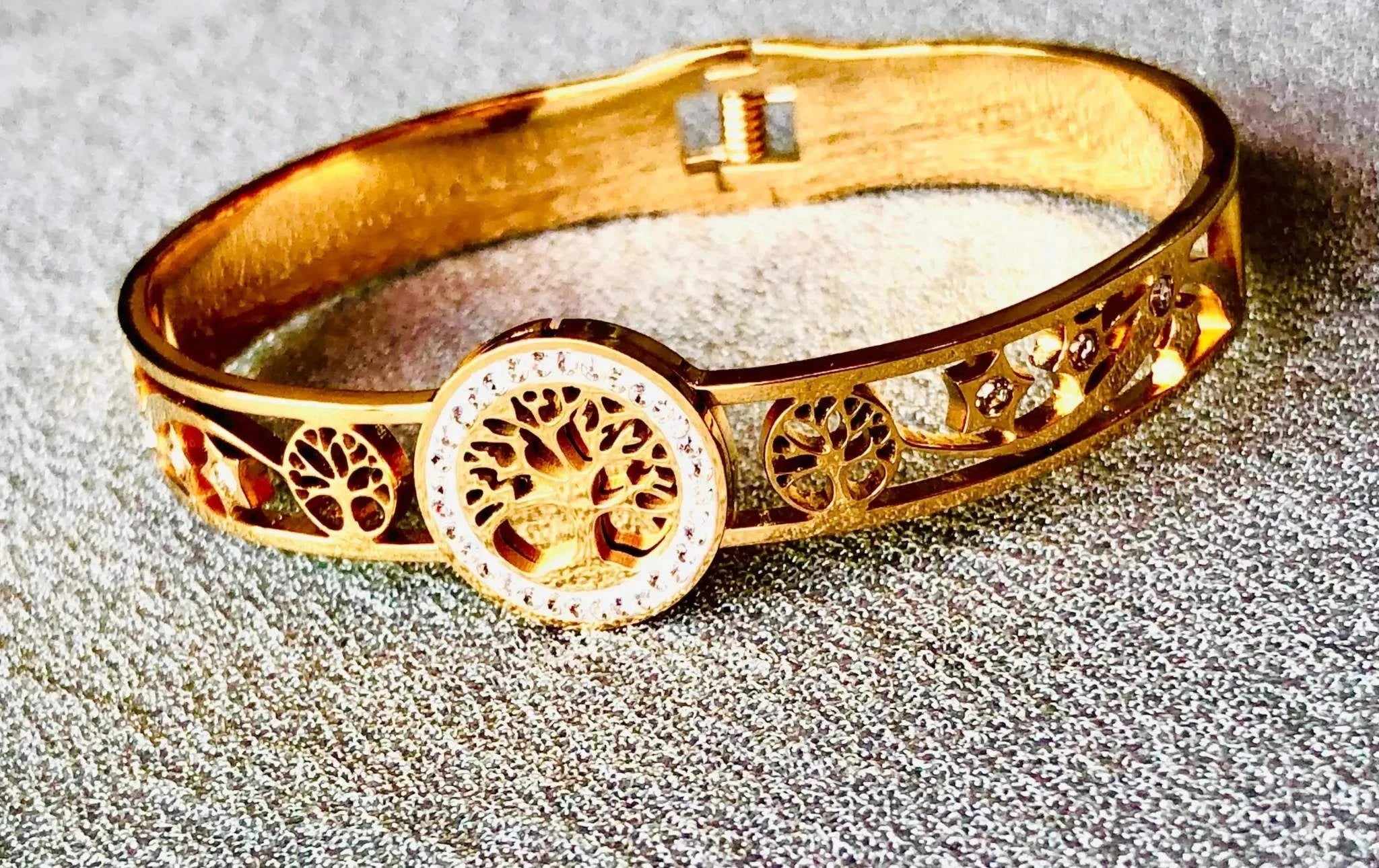 Openable golden Korean bracelet with tree and star motifs and crystal detailing on textured surface