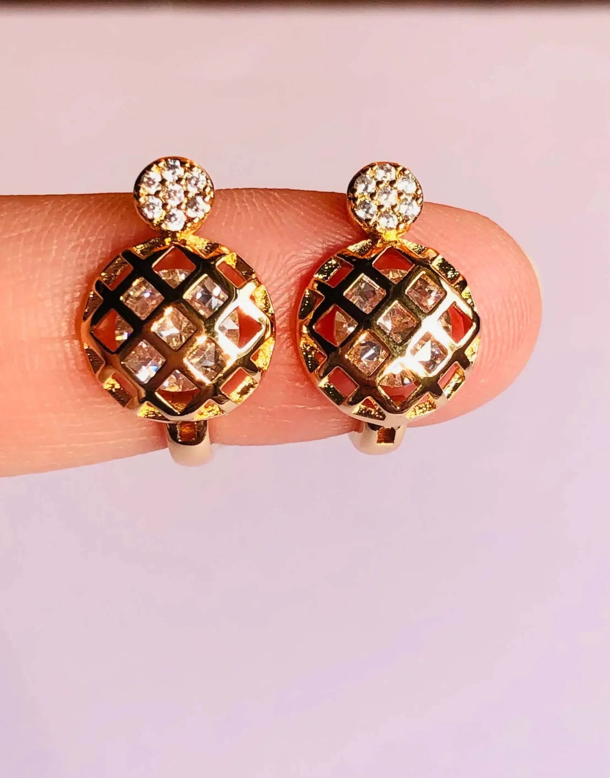 Rose gold circular stud earrings with diamond accents and intricate lattice design, elegant and luxurious accessory for any occasion