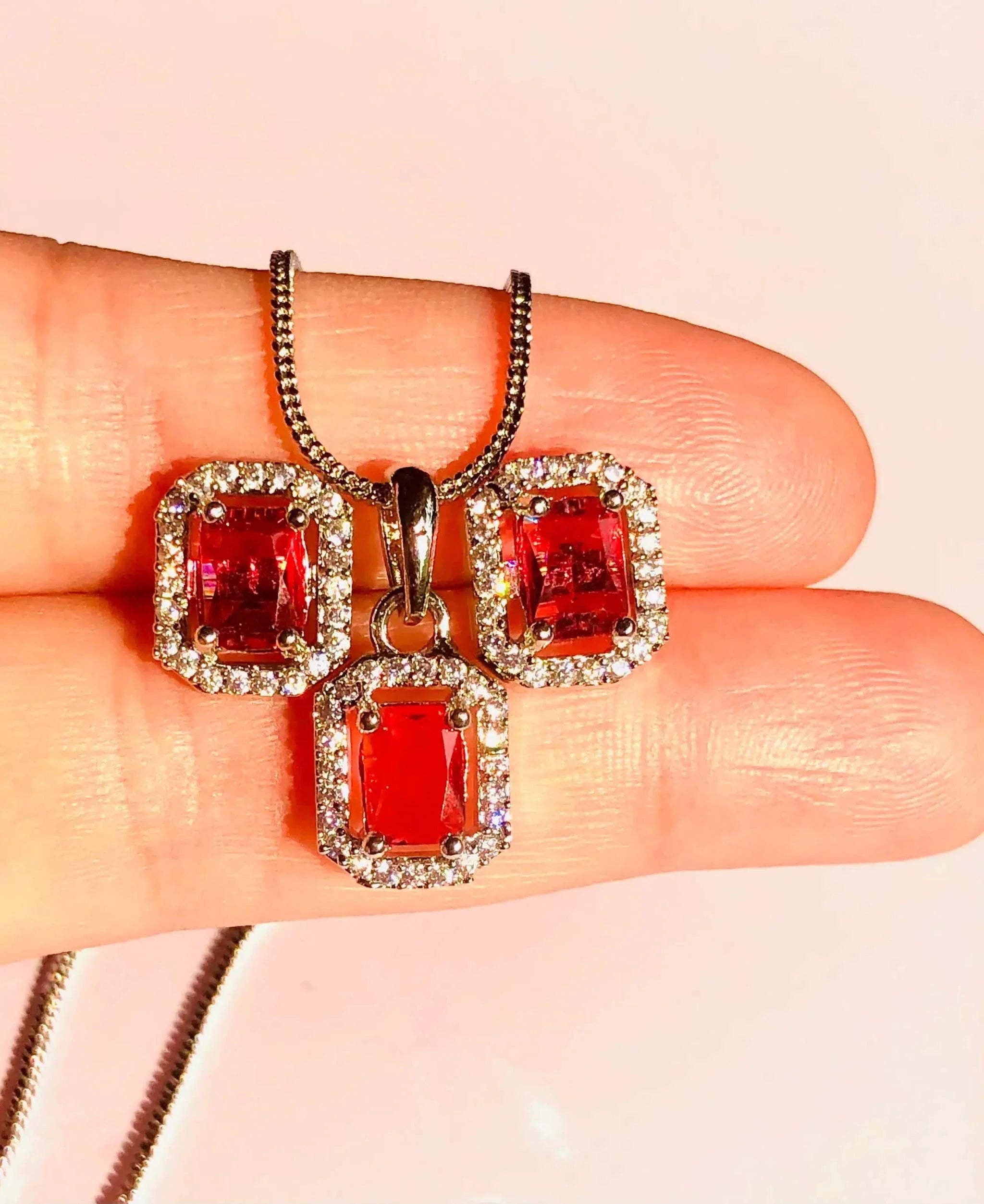 Red and silver rectangular pendant set with red stones and silver chain, elegant jewelry piece