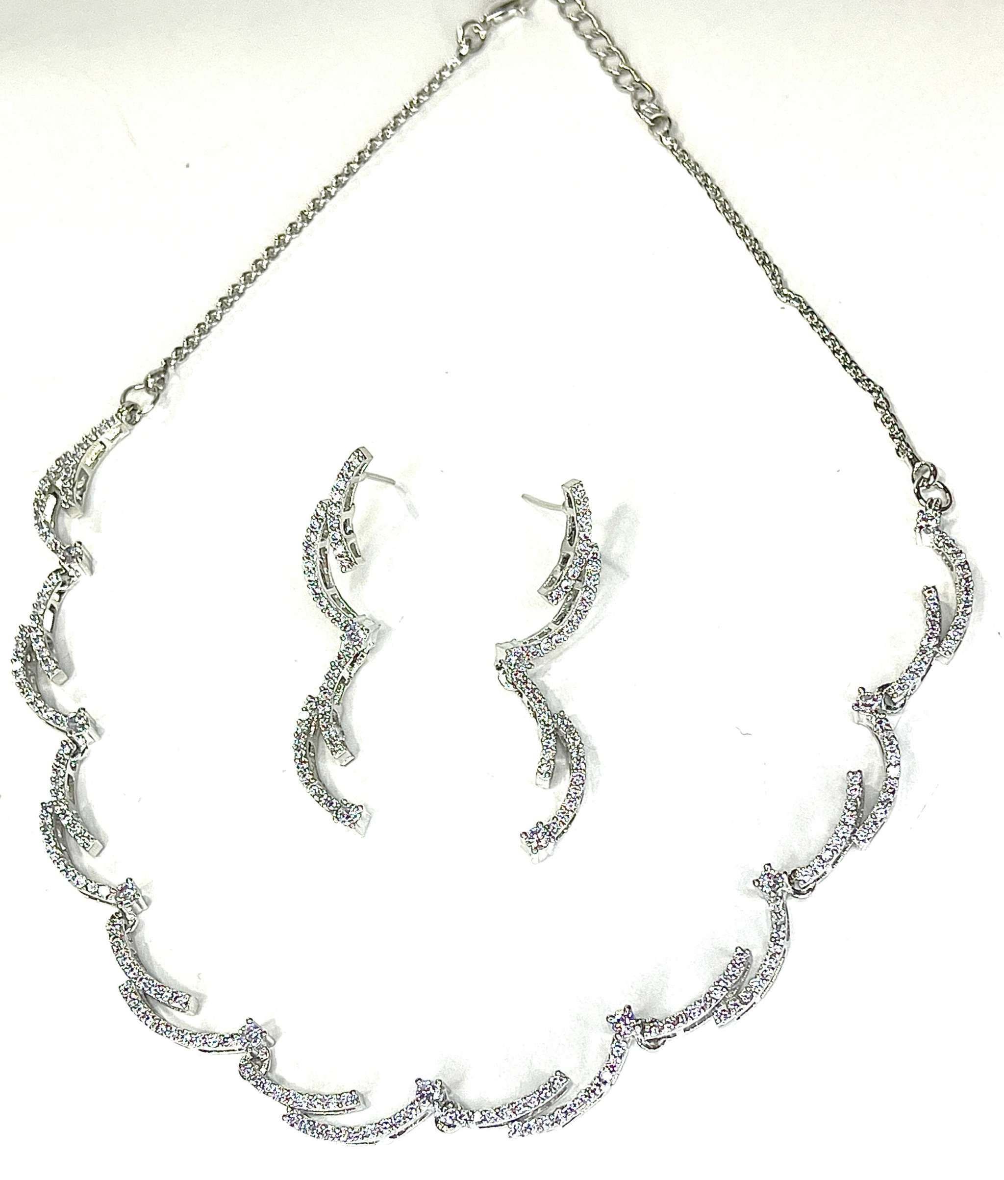 Crescent silhouette silver necklace and matching earrings set with sparkling details