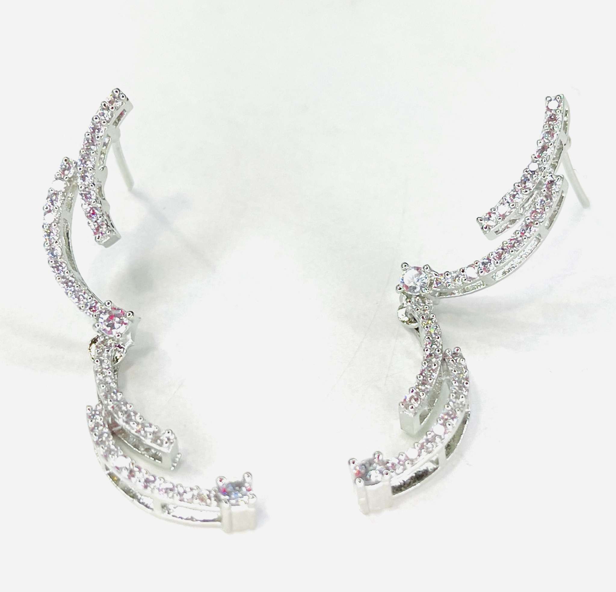 Crescent silhouette necklace set in silver with matching earrings and sparkling stones