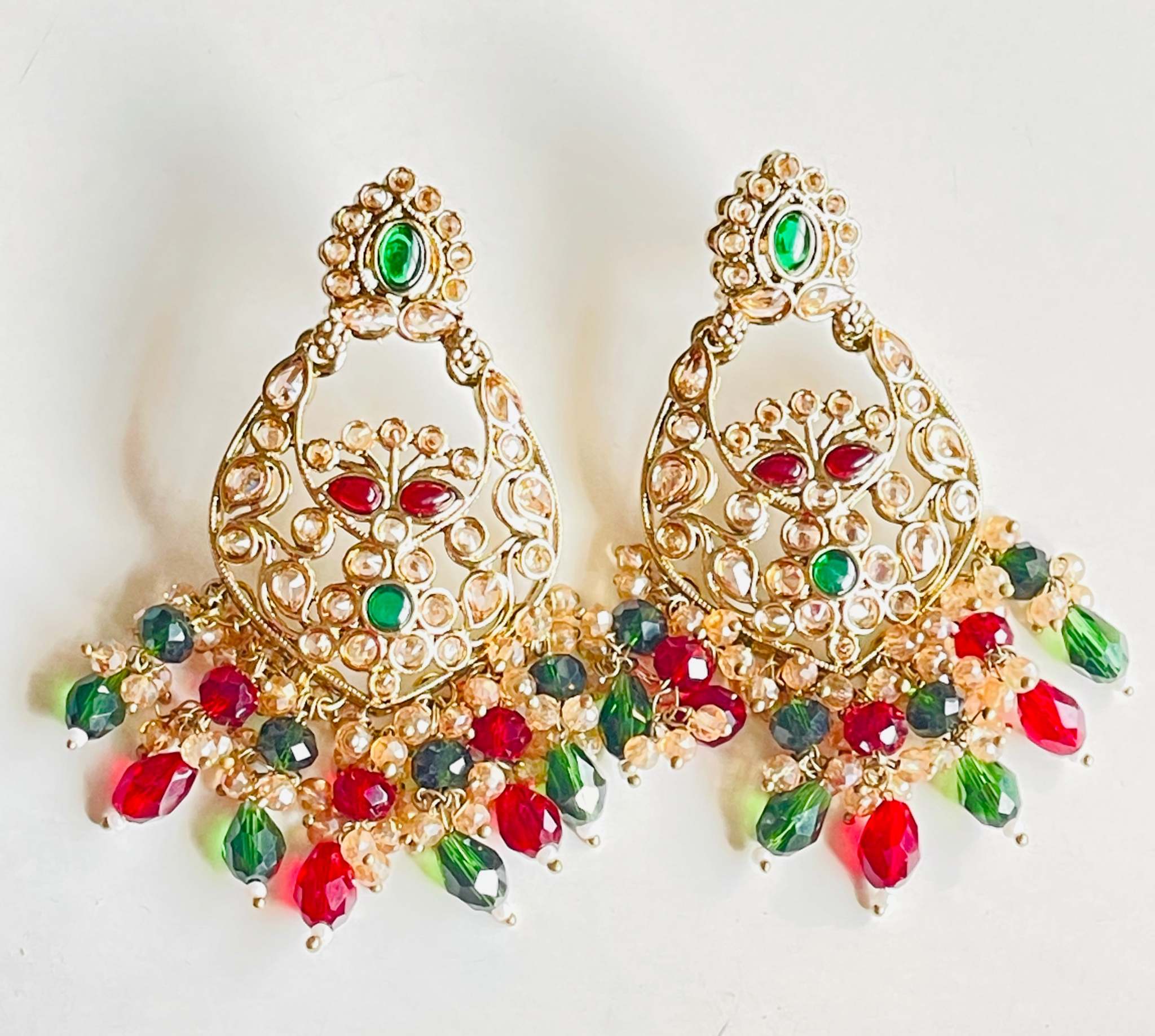 Colorful Rangeen Jhalak Chandbali earrings with intricate gold detailing, green and red stones, and dangling beads