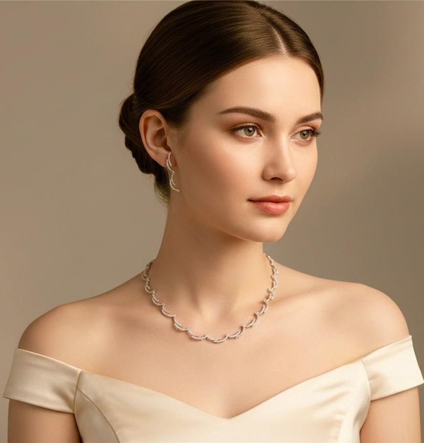 Elegant silver crescent silhouette necklace set with matching earrings on woman in off-shoulder dress