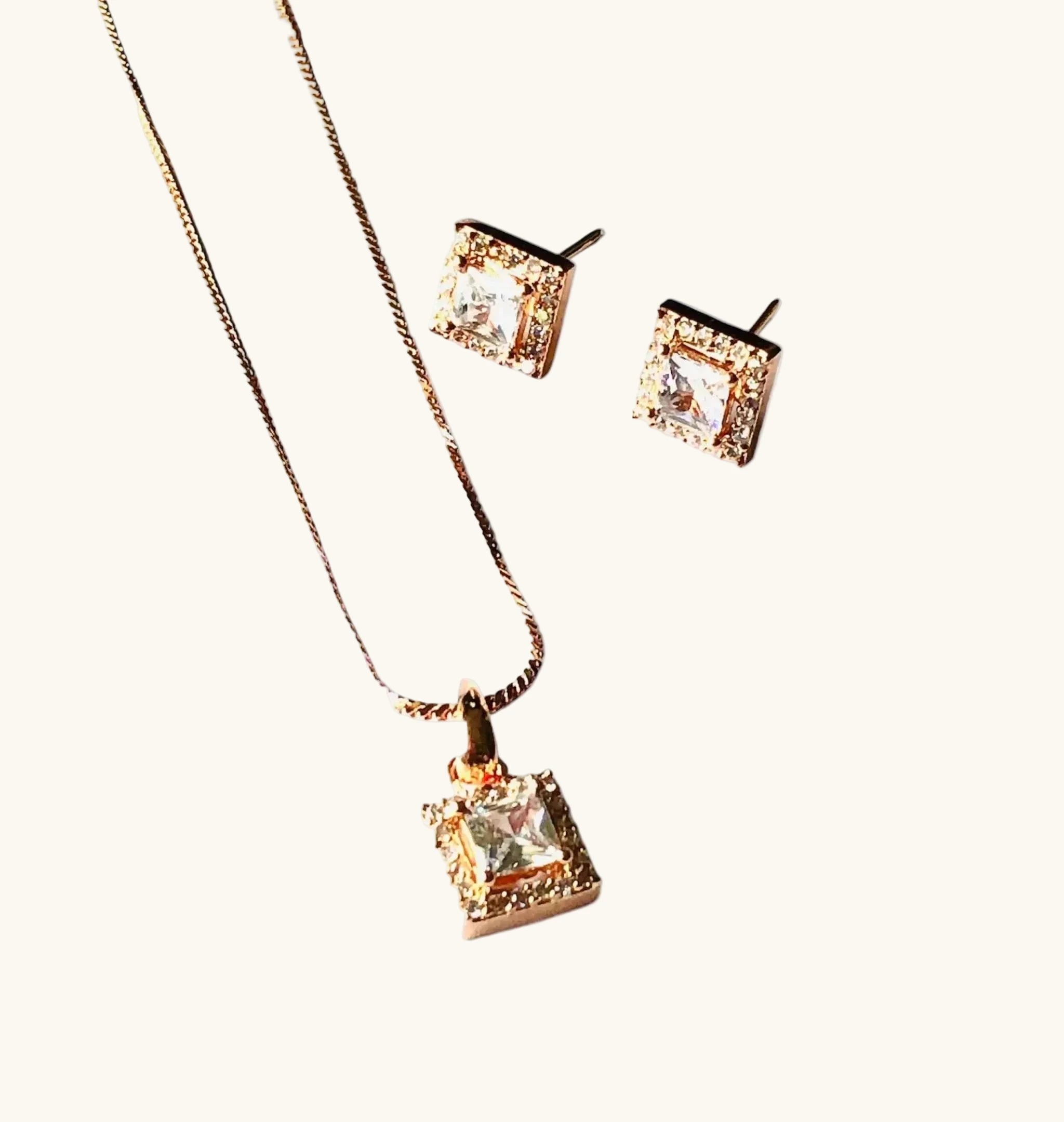 Rose gold square pendant and earrings set with white sparkling gemstones and elegant design