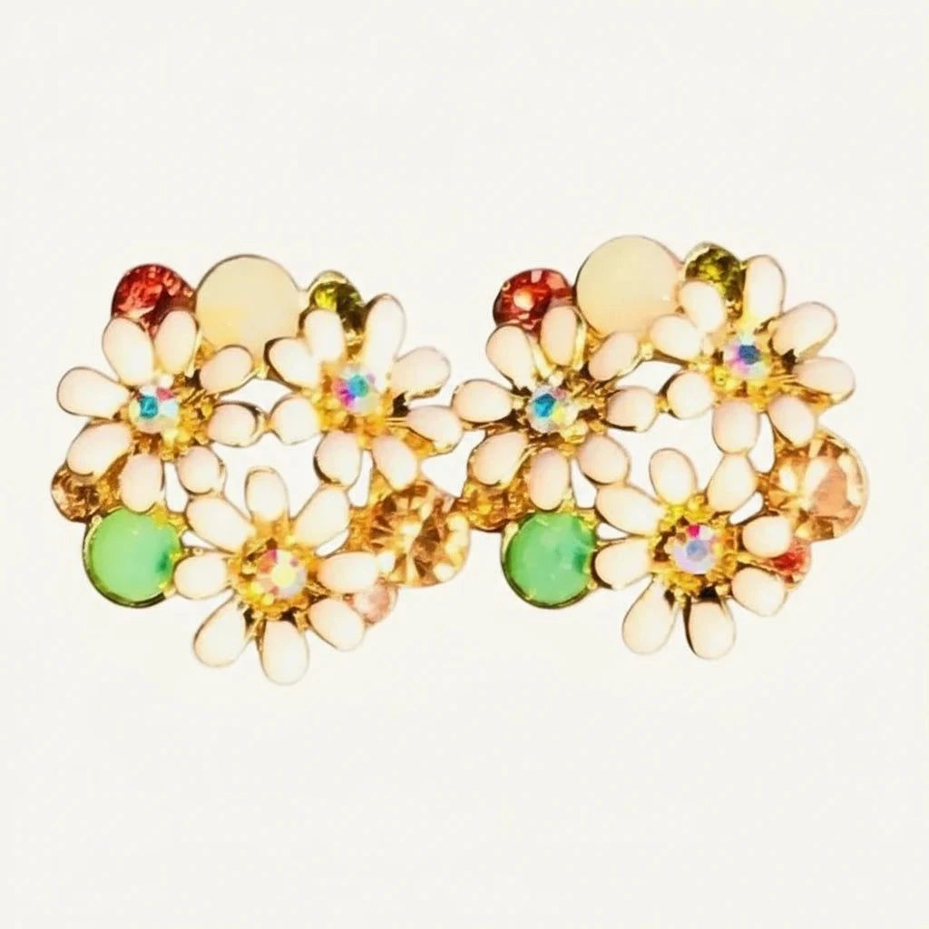 Rose gold floral stud earrings with white enamel petals and colorful gemstone accents