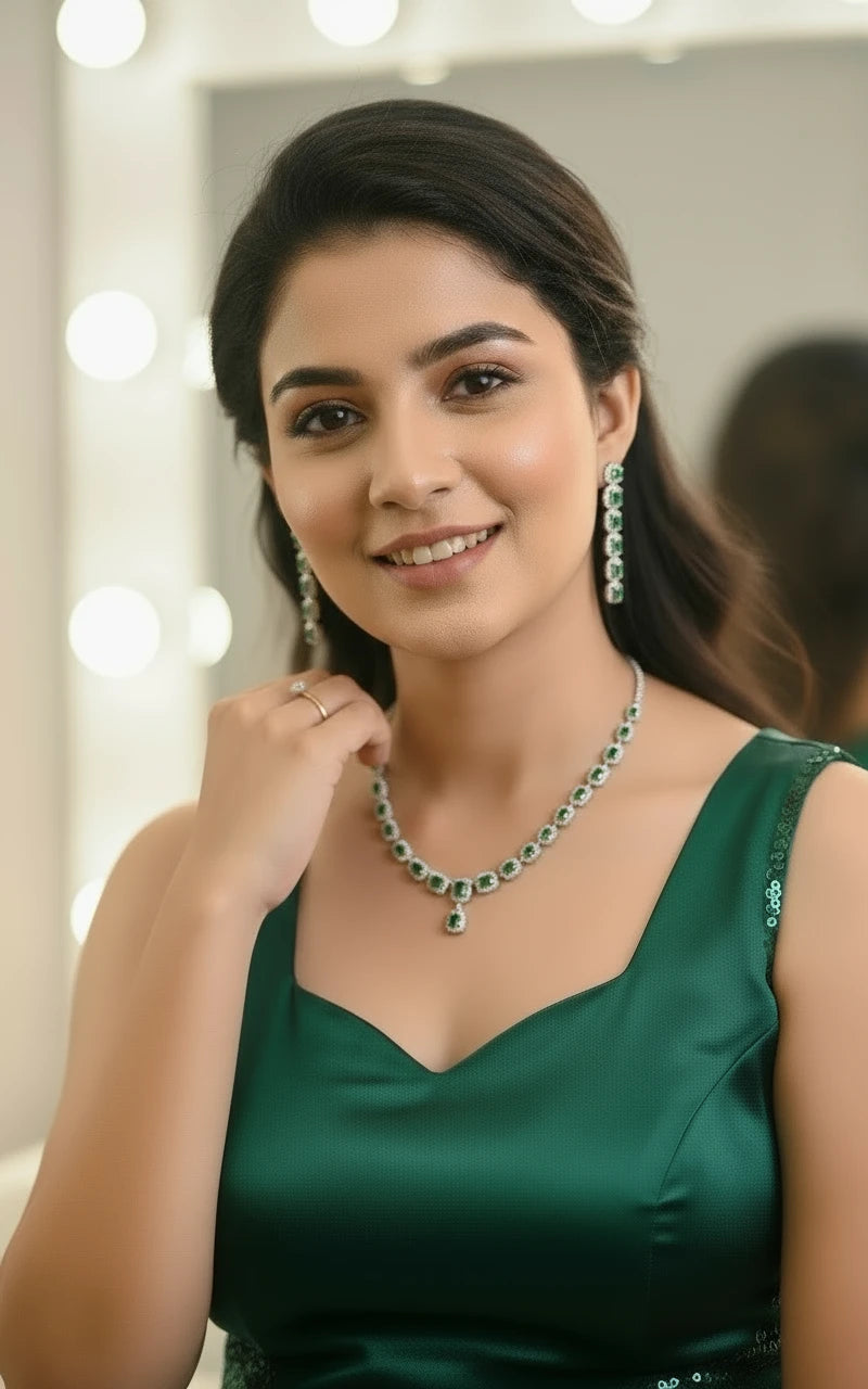 Emerald green and silver zircon necklace set with matching earrings displayed on hand
