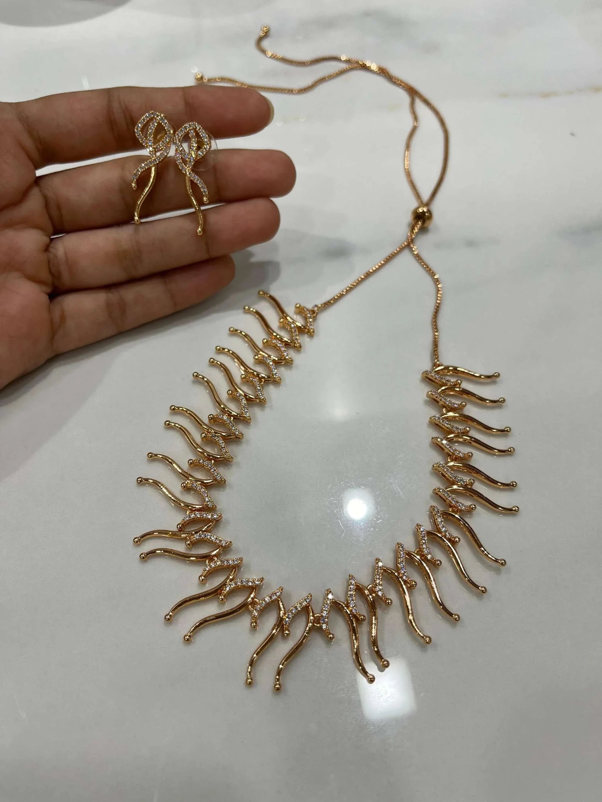 Adjustable rose gold Eclectic Elegance Necklace Set with intricate design and matching earrings