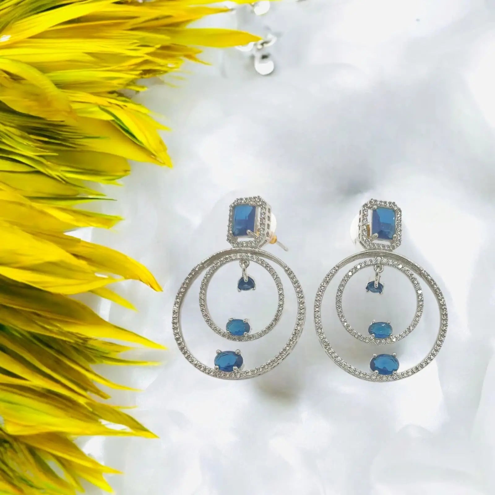 Blue gemstone drop earrings with silver hoops and pave stones.