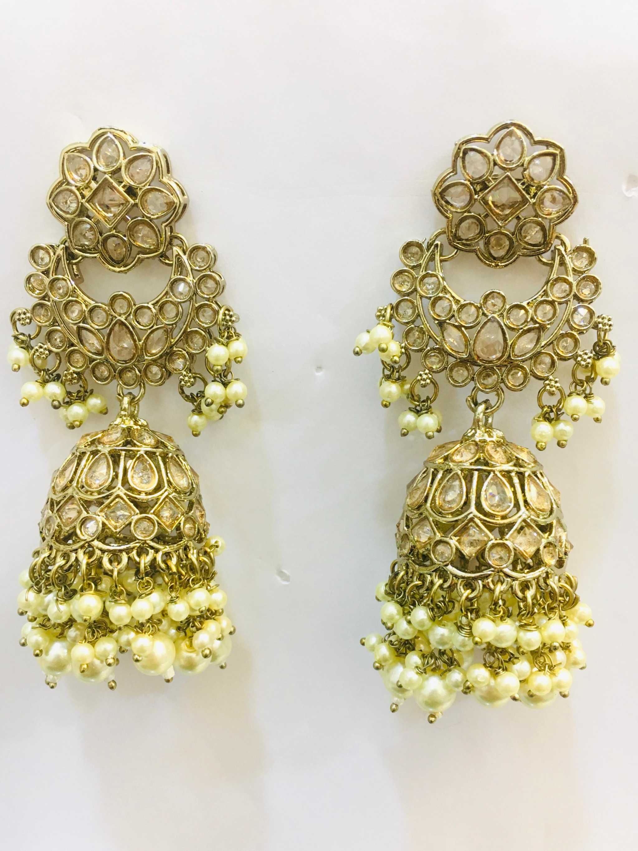 Elegant gold-toned cascading long jhumkas with intricate tiered design and pearl embellishments for weddings and festive occasions